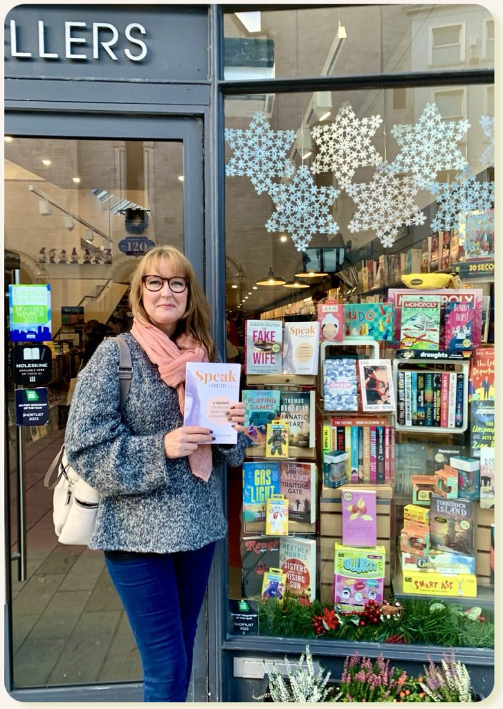 PHOTO of Vig Gleeson with her memoir Speak Truth Lies, outside O'Mahony's in Limerick Ireland.