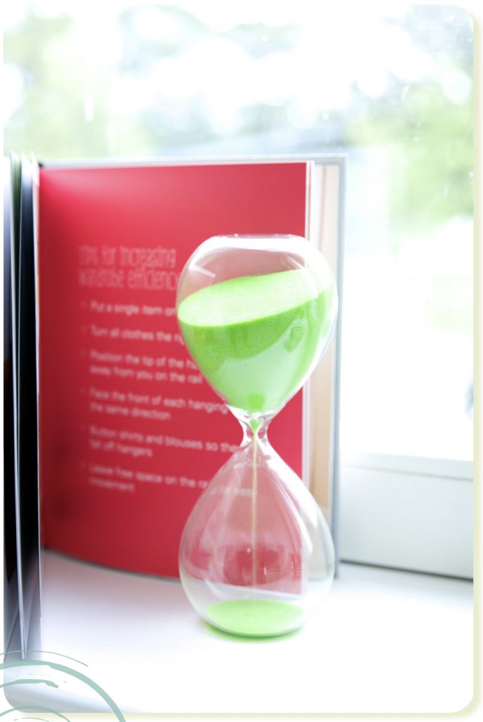 lass-hourglass-with-green-sand-running-through-measuring-passing-time-in-a-countdown-to-a-deadline-image-by-Vig-Gleeson-personal-rand-Photography-copyrigh